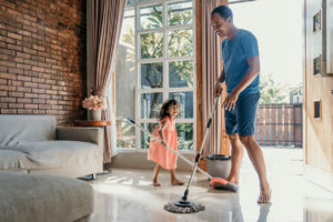 daughter helping her father mop the floors
