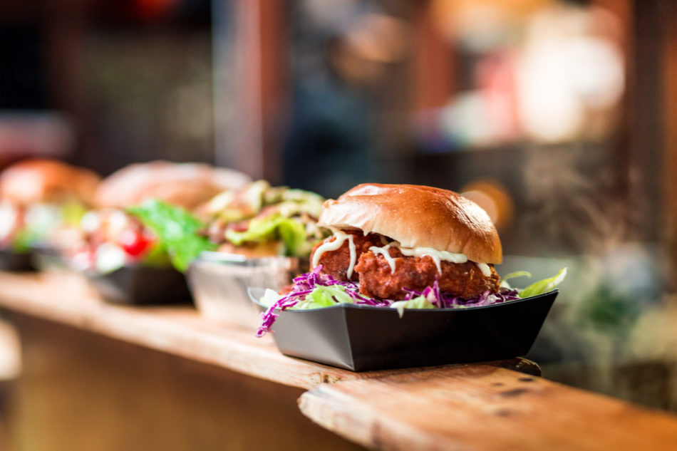 Fresh Crispy Pork Burgers in a row at Food Market