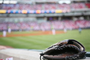 Baseball glove on the wall with a major league stadium in the background