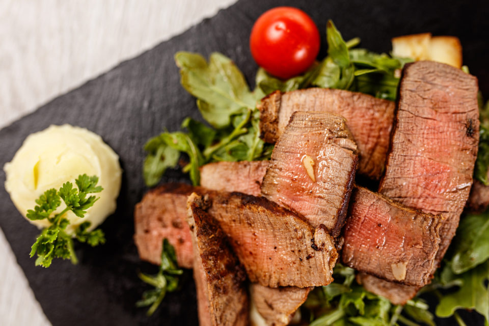 Delicious Tagliata Steak on granite board