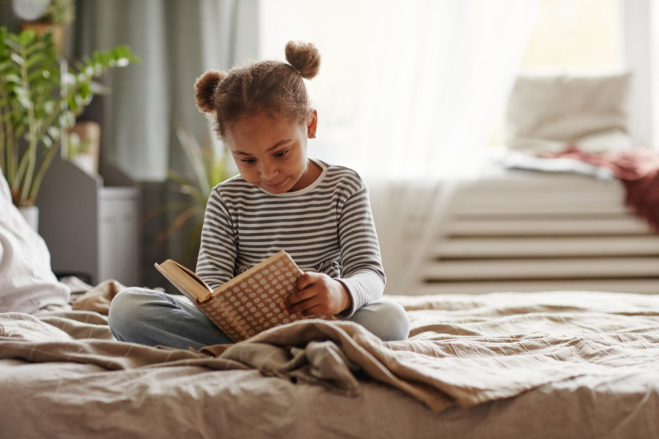 Little girl reading a book