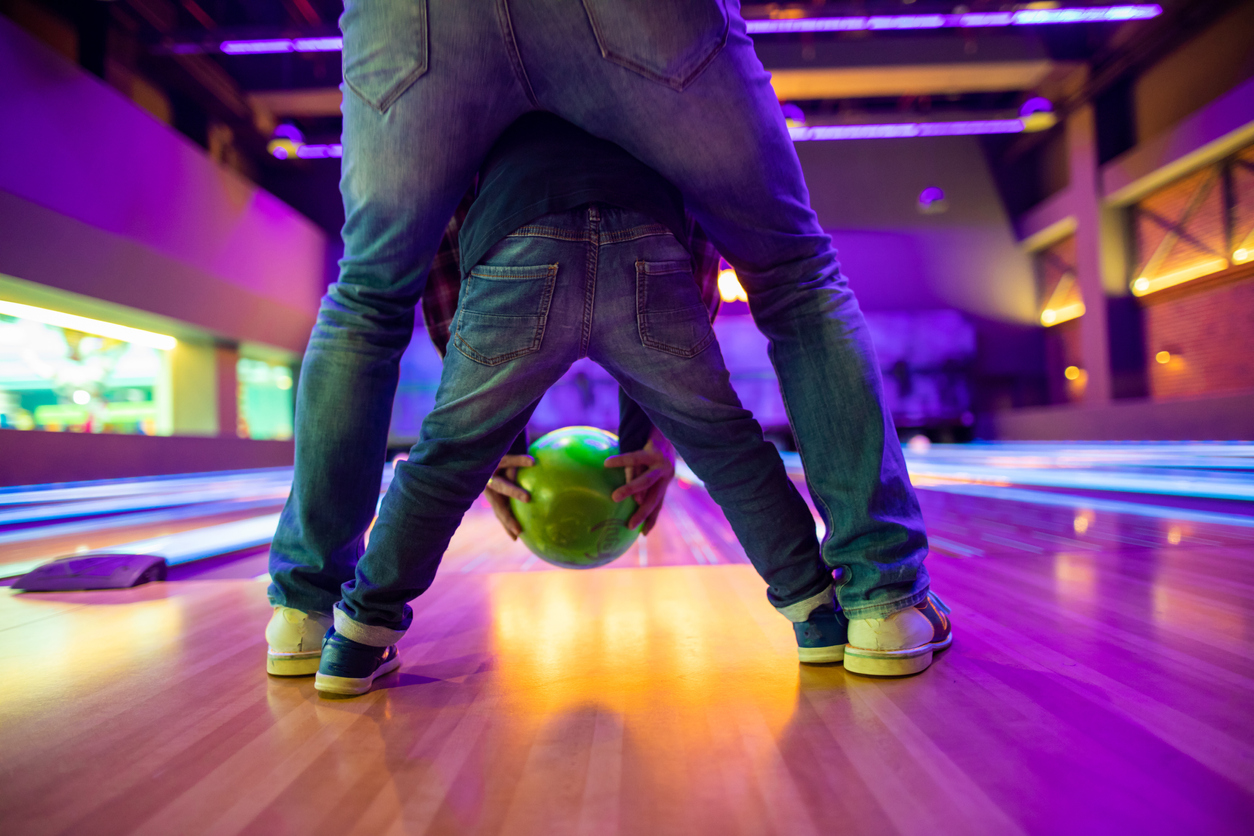 Father and son at bowling alley