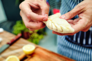 Close-up on male hands folding homemade hand pies